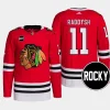 men blackhawks taylor raddysh 2023 24 rocky patch authentic home primegreen red jersey